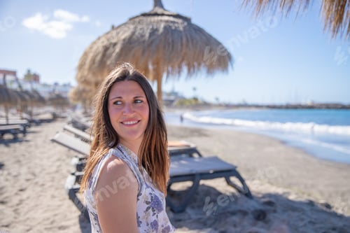 Preview: Attractive girl relaxes on a beautiful beach, photo with space on the right for writing.