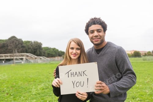 Preview: Multiethnic Couple Saying Tahnk You with a Board