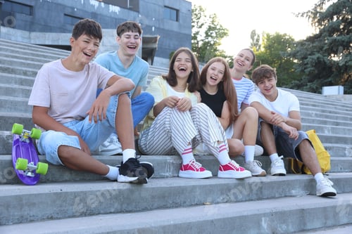 Preview: Group of happy teenage friends spending time together on steps outdoors