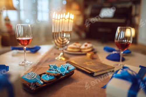 Preview: Close up of cookies at dining table during Hanukkah celebration.