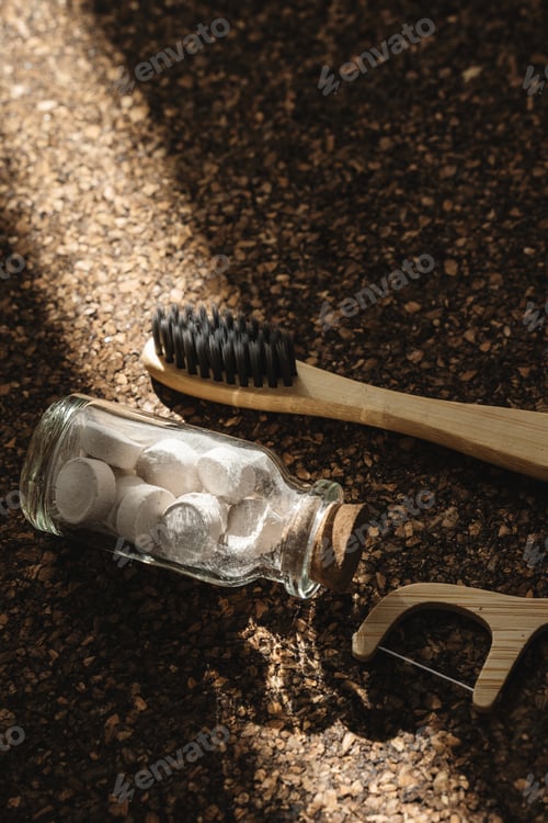 Preview: Bamboo Toothbrush, Floss Picks and Toothpaste Tablets on Cork Surface