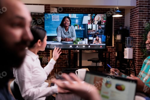 Preview: Confused startup coworkers talking during online video conference in late night meeting feeling