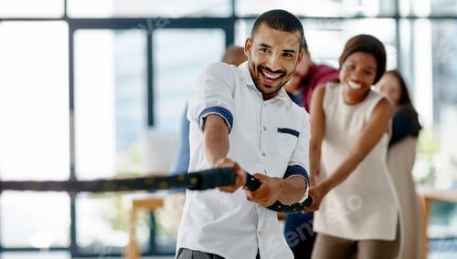 Preview: Weve got this. Cropped shot of a group of young designers pulling on a rope during tug of war.