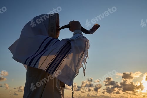 Preview: Jewish man blowing the Shofar horn of Rosh Hashanah - New Year. Sunset Shofar