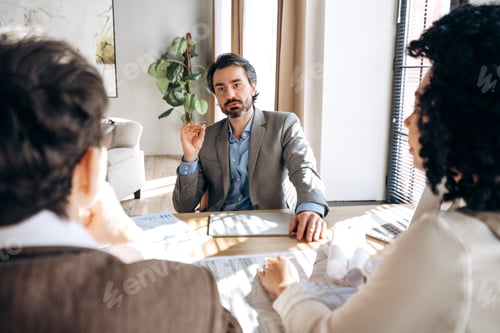 Preview: Architect explaining project details to clients during a meeting