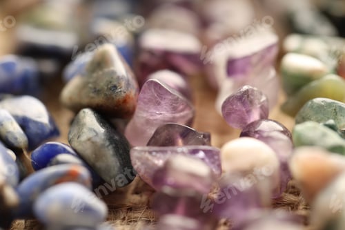 Preview: Many different healing stones on table, closeup
