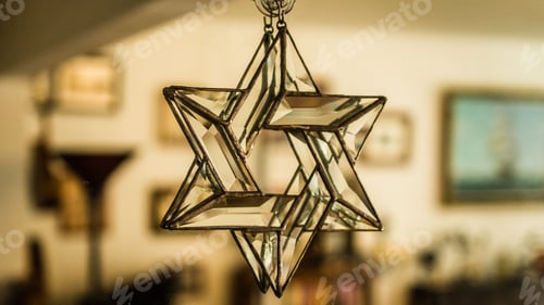Preview: Closeup of Star of David made of glass hanging in a room