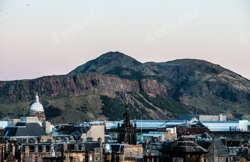 Preview: Beautiful shot of city buildings with mountains in the distance