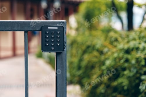 Preview: Keypad entry system near a gate in a garden area during daytime