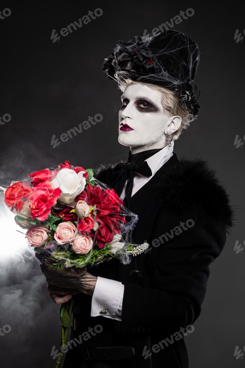 Preview: Handsome young man in an elaborate Halloween costume with a bouquet of flowers