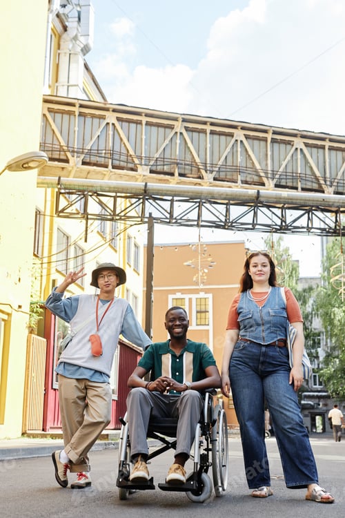 Preview: Group of Friends with Black Man using Wheelchair Posing in Urban City