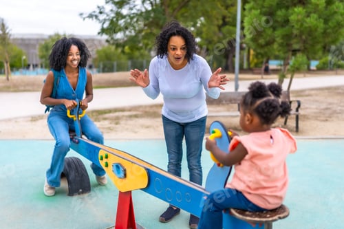 Preview: African mother and grandmother spending time at playground with girl