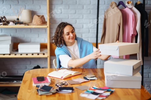 Preview: Small business owner, entrepreneur, seller using tablet checking ecommerce clothing store orders.