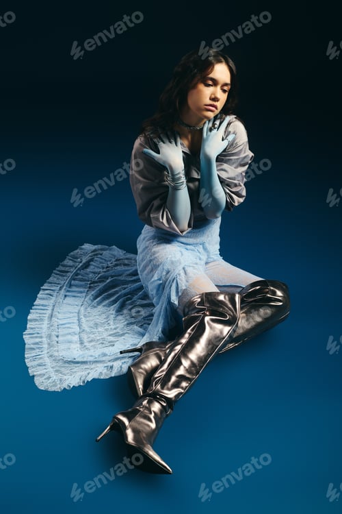 Preview: Stylish young woman showcases vibrant fashion in creative studio setting