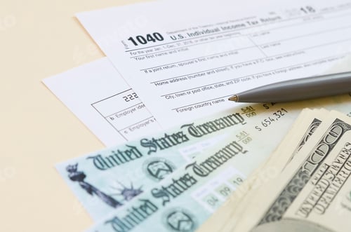 Preview: 1040 Individual Income tax return form with Refund Check and hundred dollar bills