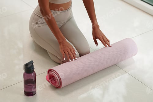 Preview: Woman Prepares Her Yoga Mat for Exercise