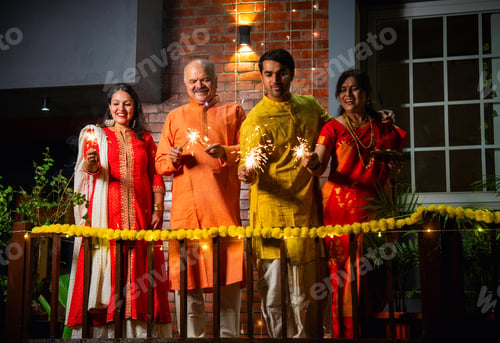 Preview: Enjoying festive sparkles on balcony, joyful Indian family celebrates Diwali in traditional clothing