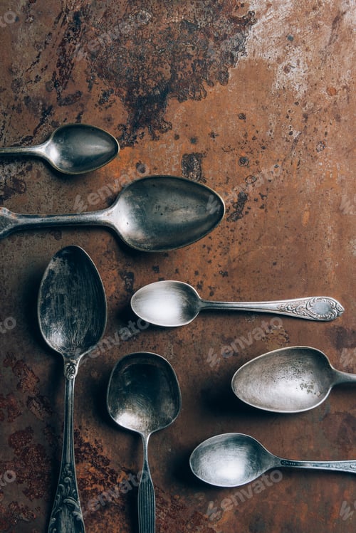 Preview: top view of silver spoons on grungy table