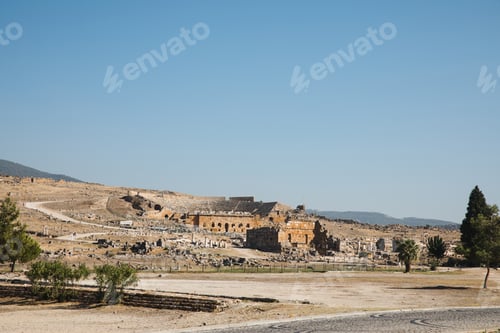 Preview: beautiful architecture, rural road and mountains on horizon in pamukkale, turkey