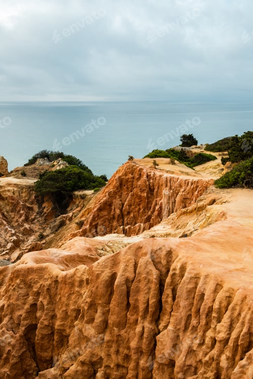 Preview: Red Cliffs and Turquoise Waters at Algarve Beach in Portugal