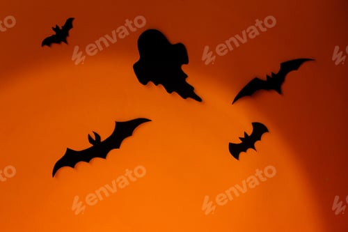 Preview: Spooky Halloween. Black ghosts and bats decorations on orange background. Happy Halloween