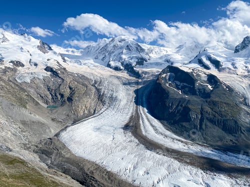Preview: A glacier and snow covered mountain tops in the Swiss Alps