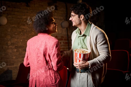 Preview: joyous attractive diverse couple having good time on date and smiling happily at each other