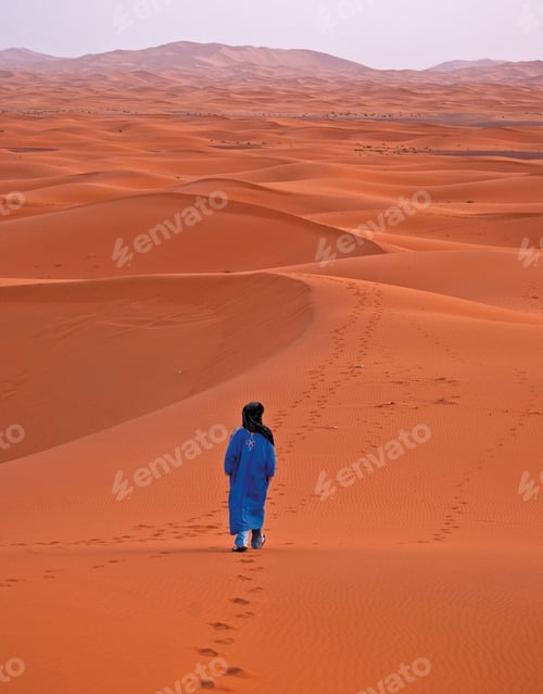 Preview: Vertical back view of a male walking in the desert, Morocco, Africa