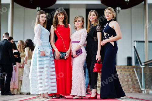 Preview: Fantastic young women in awesome fashionable dresses posing in the restaurant.