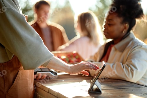 Preview: Young Black Woman Paying with Contactless Card at Outdoor Market Checkout