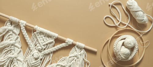 Preview: Macrame. Handmade macrame weaving and cotton threads on a rustic wooden stick.