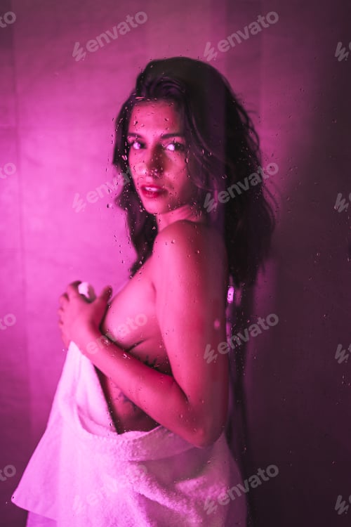 Preview: sexy brunette Caucasian girl with towel at the end of the shower with sensual look