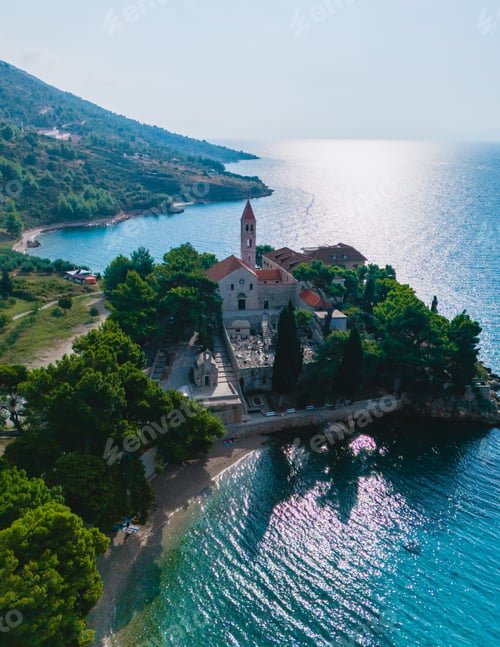 Preview: A serene view of Brac Island's coastline and historic church bathed in sunlight