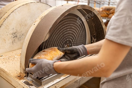 Preview: Worker grate bread crust in factory