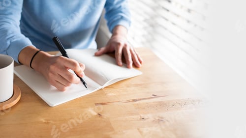 Preview: Man writing in a journal while at home in the new normal
