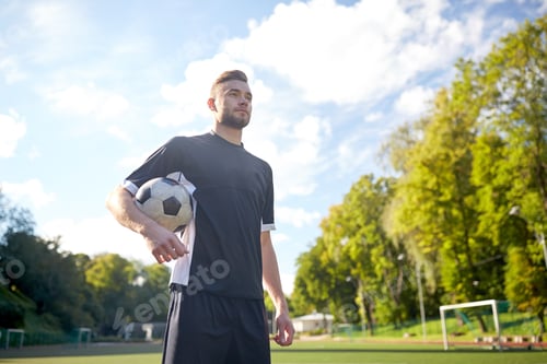 Preview: soccer player with ball on football field