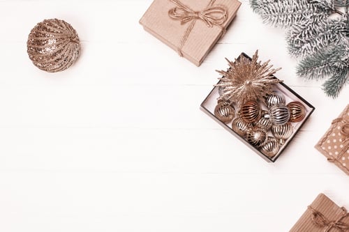 Preview: Festive decorations and gifts arranged on a wooden table for the holiday season