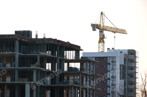 Preview: Tower cranes and high residential apartment buildings under construction. Real estate development
