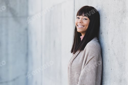 Preview: Outdoor portrait of beautiful African American woman outside with black hair and bangs