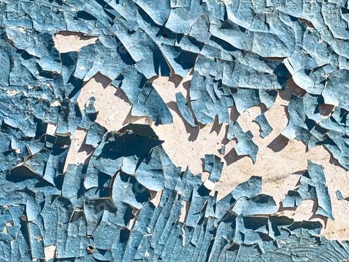 Preview: Textured cracked paint on a concrete wall close up.