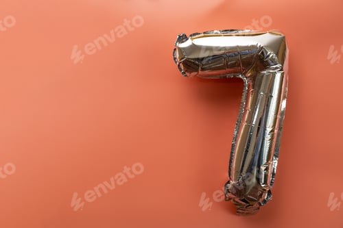 Preview: 7 seven metallic balloon isolated on pink background. Greeting card silver foil balloon number Happy