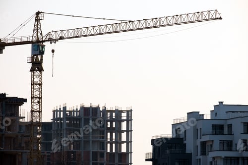 Preview: Tower cranes and high residential apartment buildings under construction. Real estate development