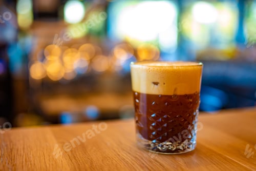 Preview: Iced Coffee Drink in a Crystal Glass a Wooden Bar Table