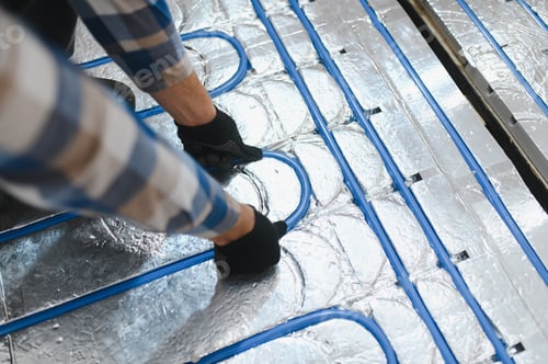 Preview: Master installs the overlapping thermal insulation in the room. Floor heating installation.