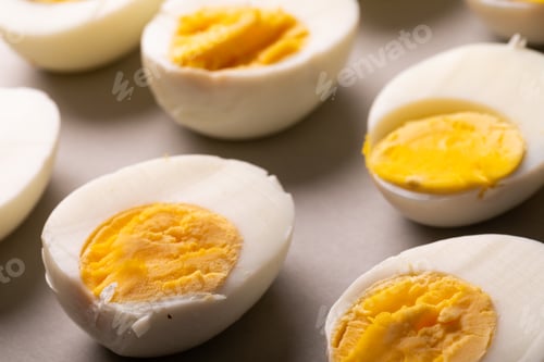 Preview: High angle view of fresh white boiled eggs with yellow yolks on table