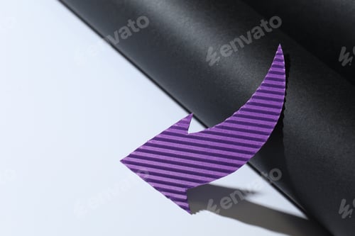 Preview: One purple paper arrow on color background, closeup. Space for text