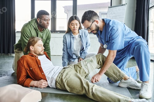 Preview: first aid seminar, medical instructor in eyeglasses and uniform applying compression bandage on leg