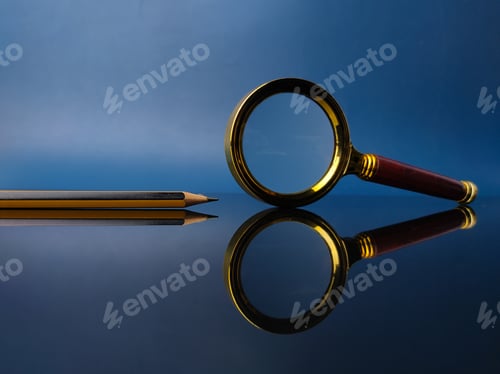 Preview: Reflection vintage magnifying glass and pencil on a black acrylic board
