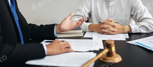 Preview: Two people are sitting at a table with papers and a gavel