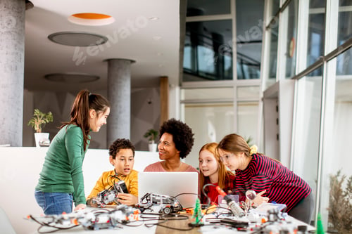 Preview: happy kids with their African American female science teacher with laptop